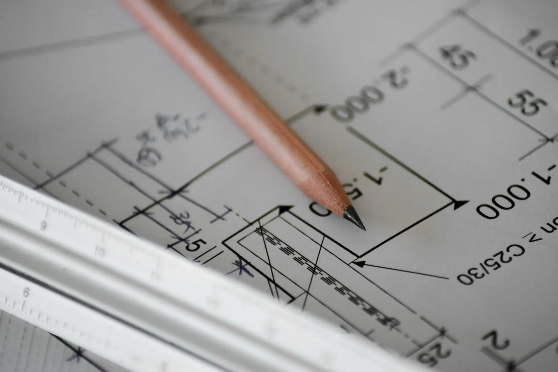 Pencil and scale rule on technical drawings
